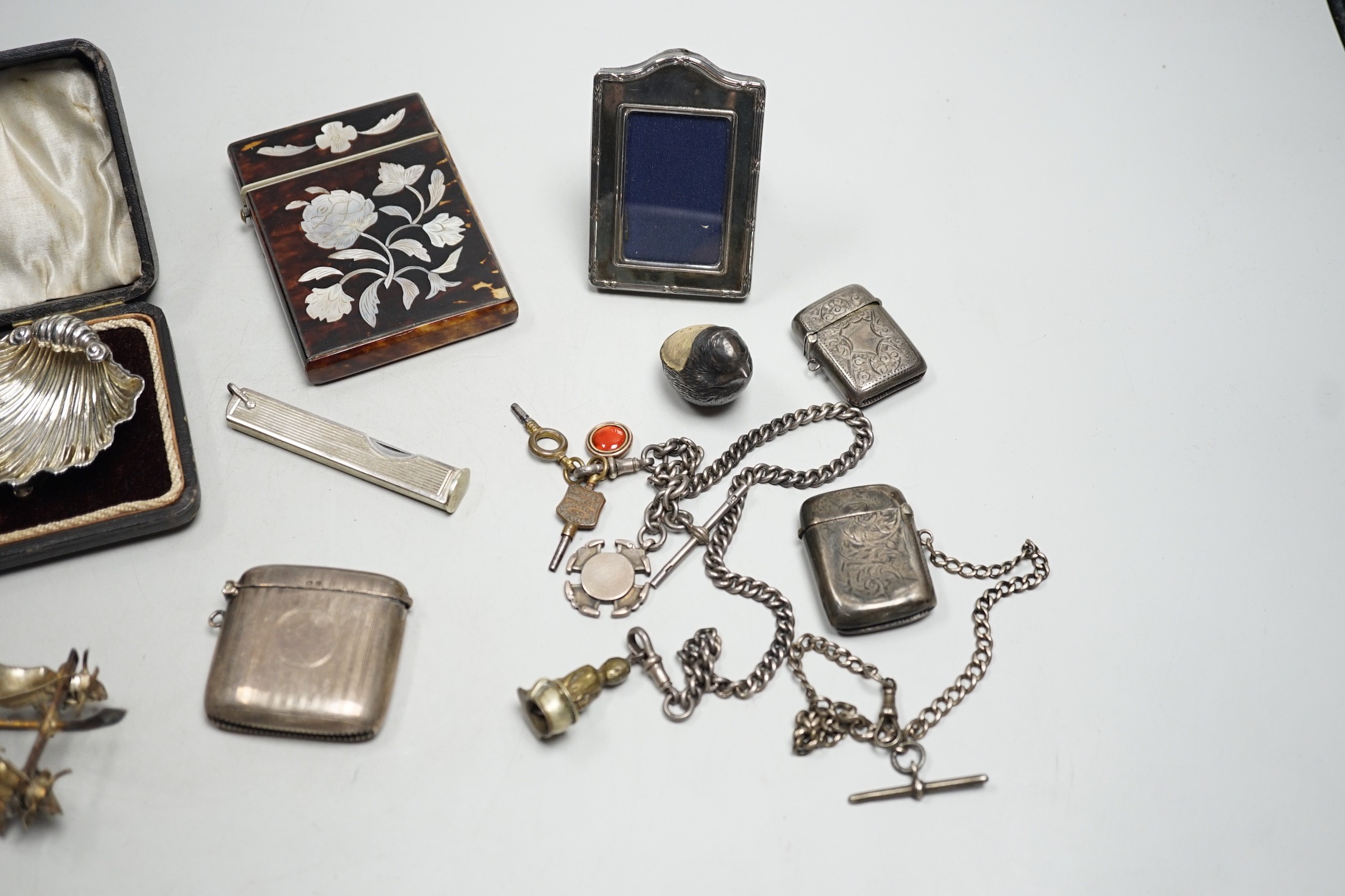 A cased pair of Edwardian silver shell salts, with spoons, and other items including Edwardian silver mounted bird pin cushion, by Sampson Mordan & Co, vesta cases, inlaid tortoiseshell card case etc.